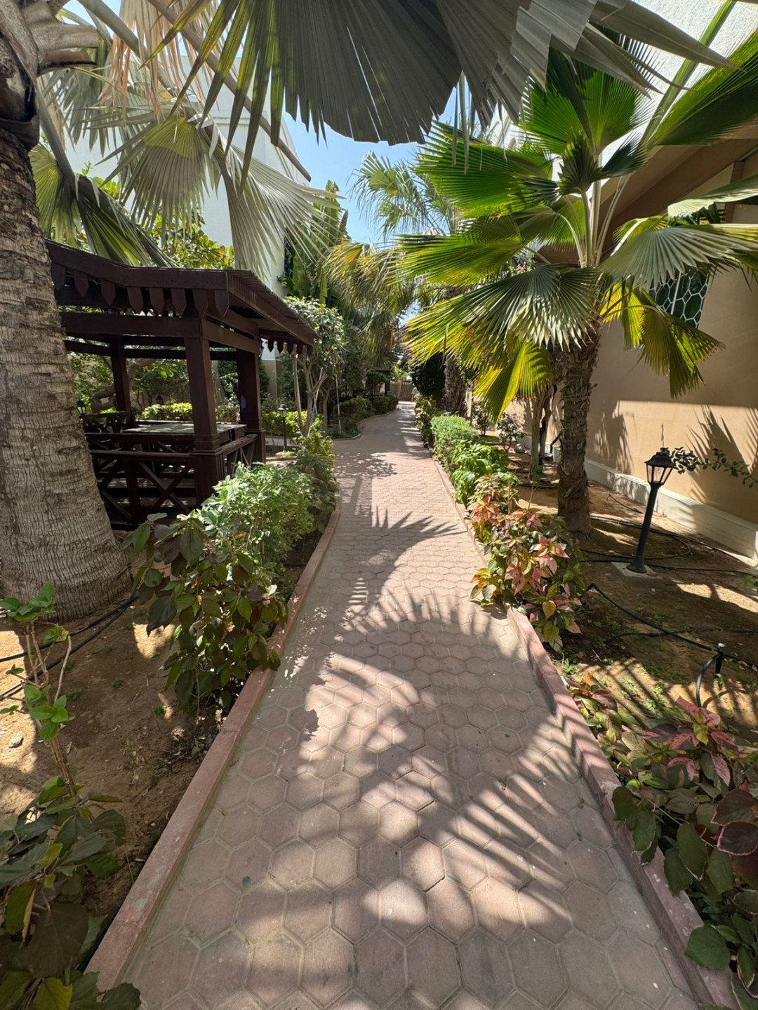Luxury two-bedroom apartment with living room and majlis for annual rent in Sharjah, featuring a garden, kids' area, and sea view.