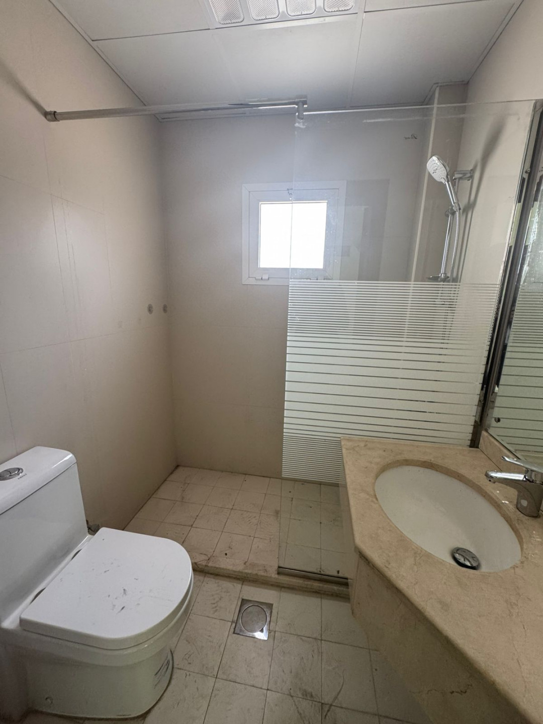 Luxury two-bedroom apartment with living room and majlis for annual rent in Sharjah, featuring a garden, kids' area, and sea view.
