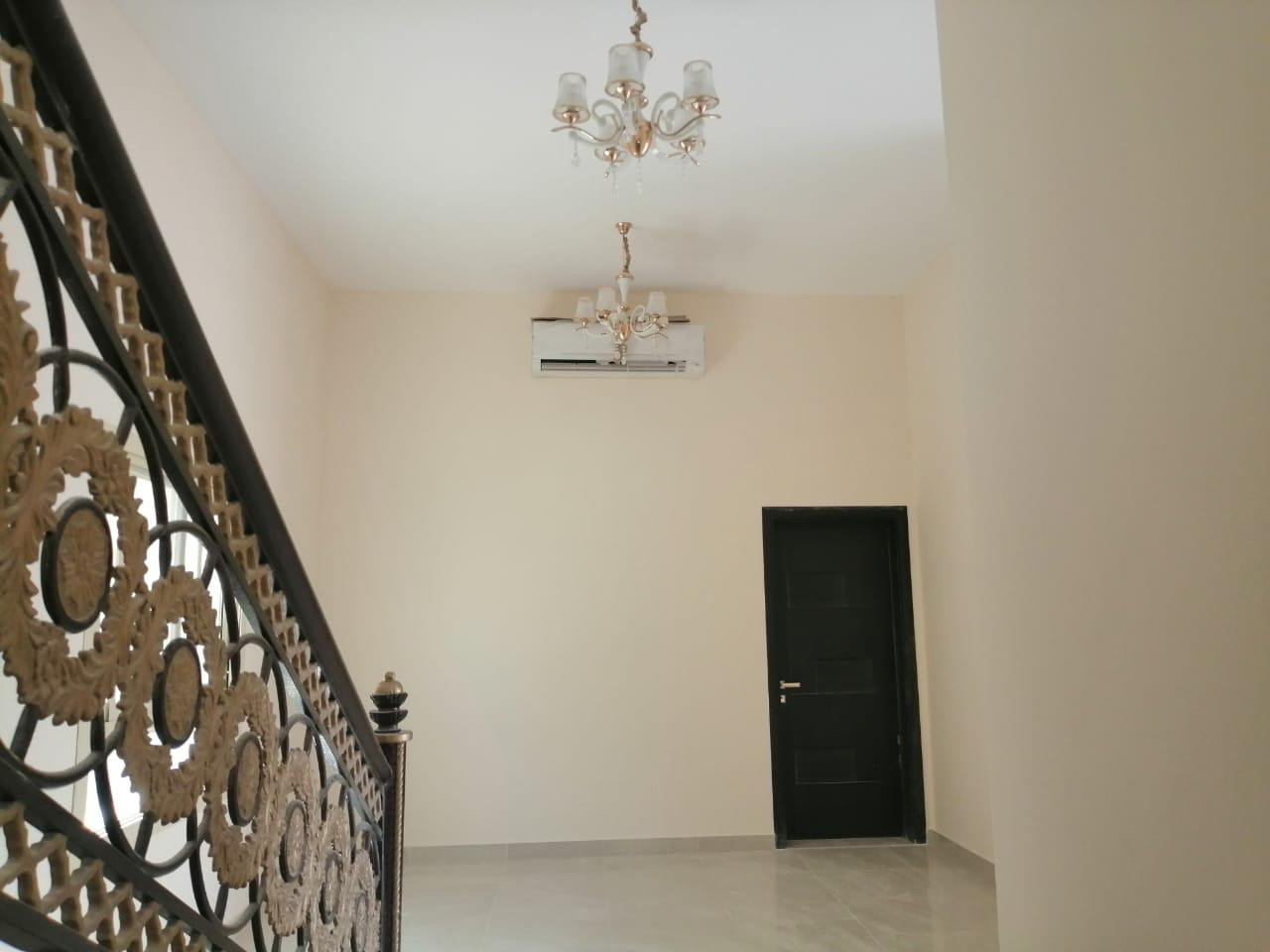 Two-story villa for rent in Al Ghafia, prime location on a main street, 5 master bedrooms and a laundry room