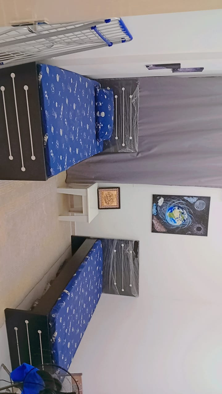 A room for one or two young men in a clean, family-friendly apartment.