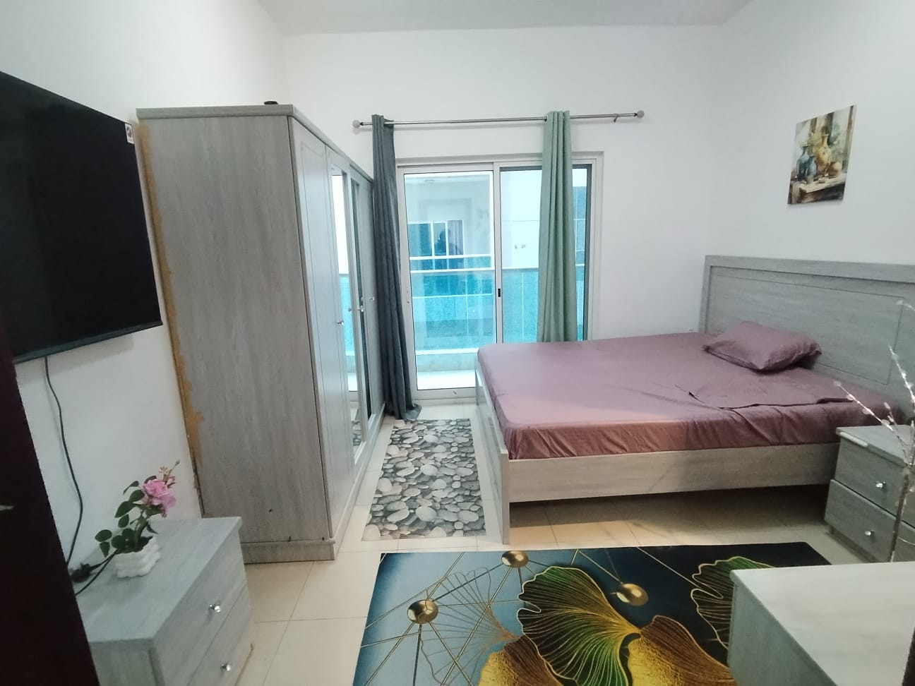 Master bedroom with balcony in a girls' apartment