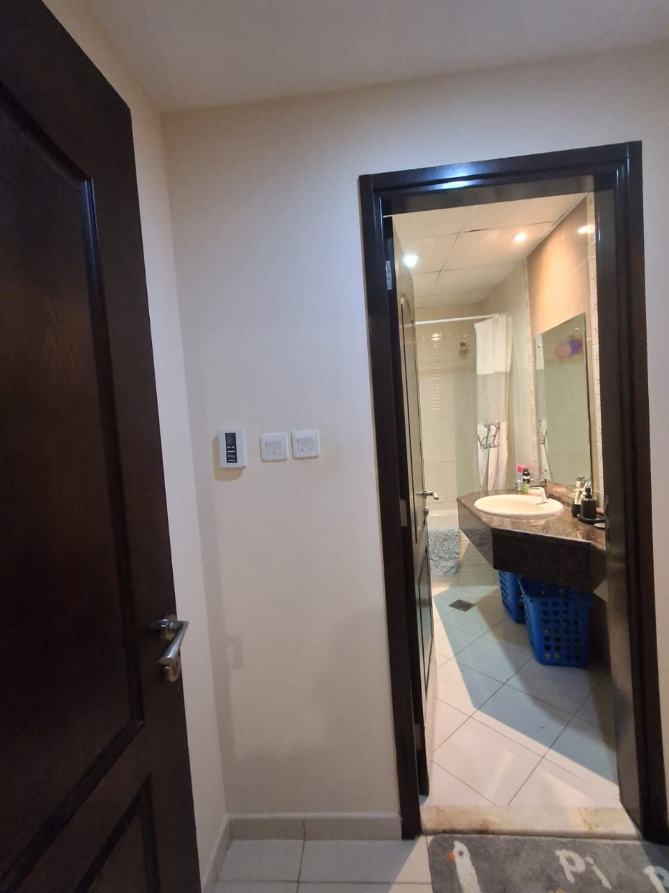 Master bedroom with private bathroom, sofa, and TV