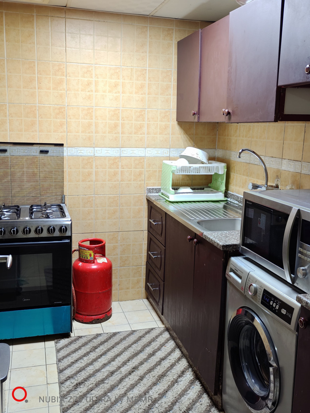 One bedroom and living room furnished with hotel furniture