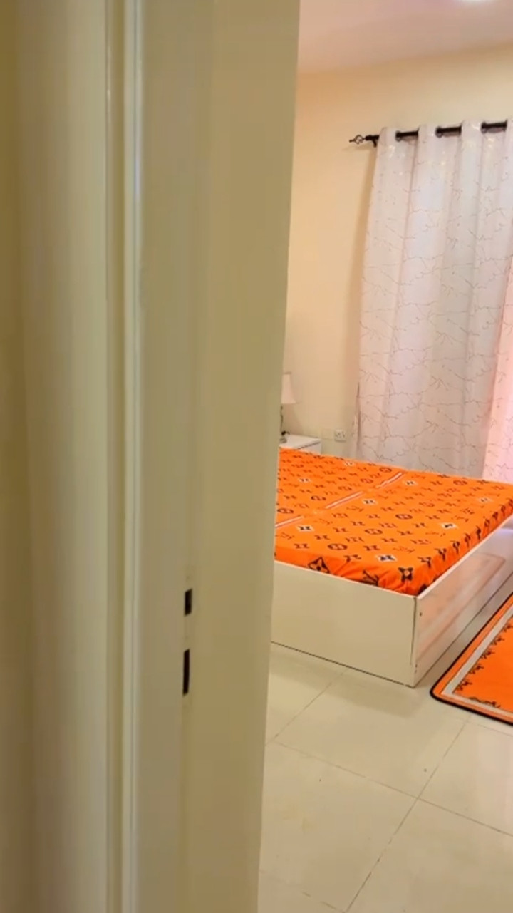 One bedroom and living room, clean furnishings, with an open view.
