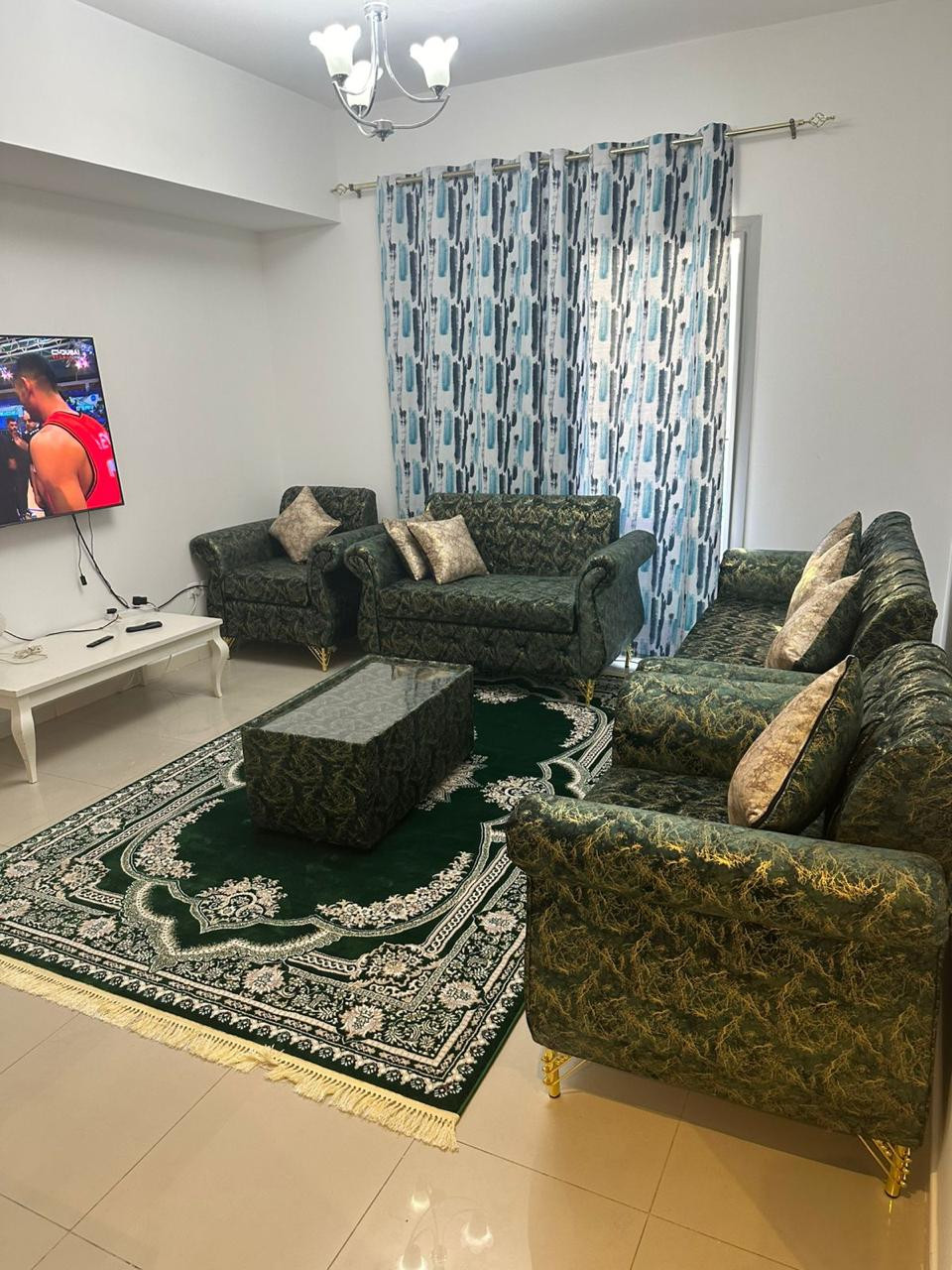 One bedroom and living room, clean furnishings, with a balcony.