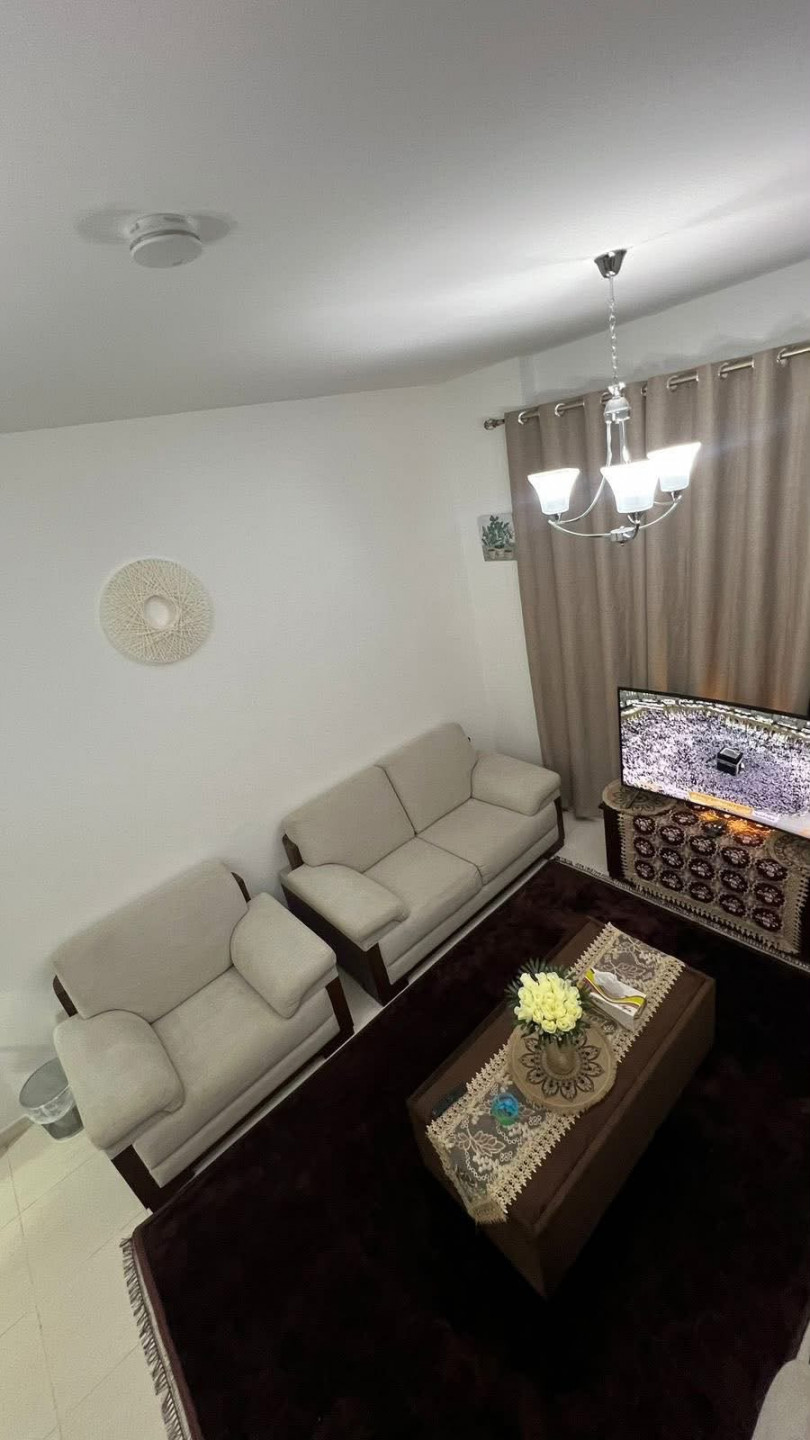 One bedroom and living room furnished with clean furniture in a family building