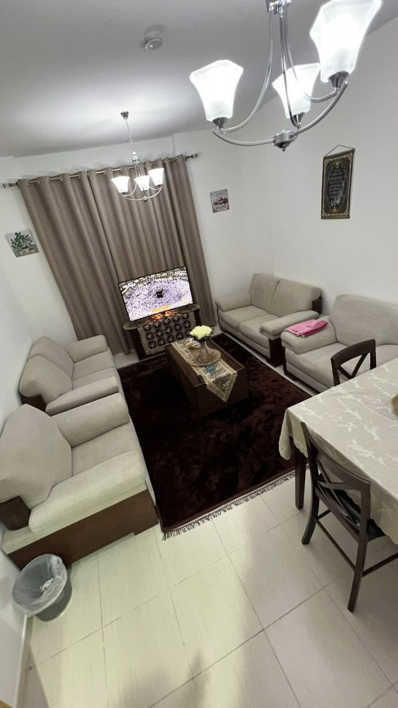 One bedroom and living room furnished with clean furniture in a family building