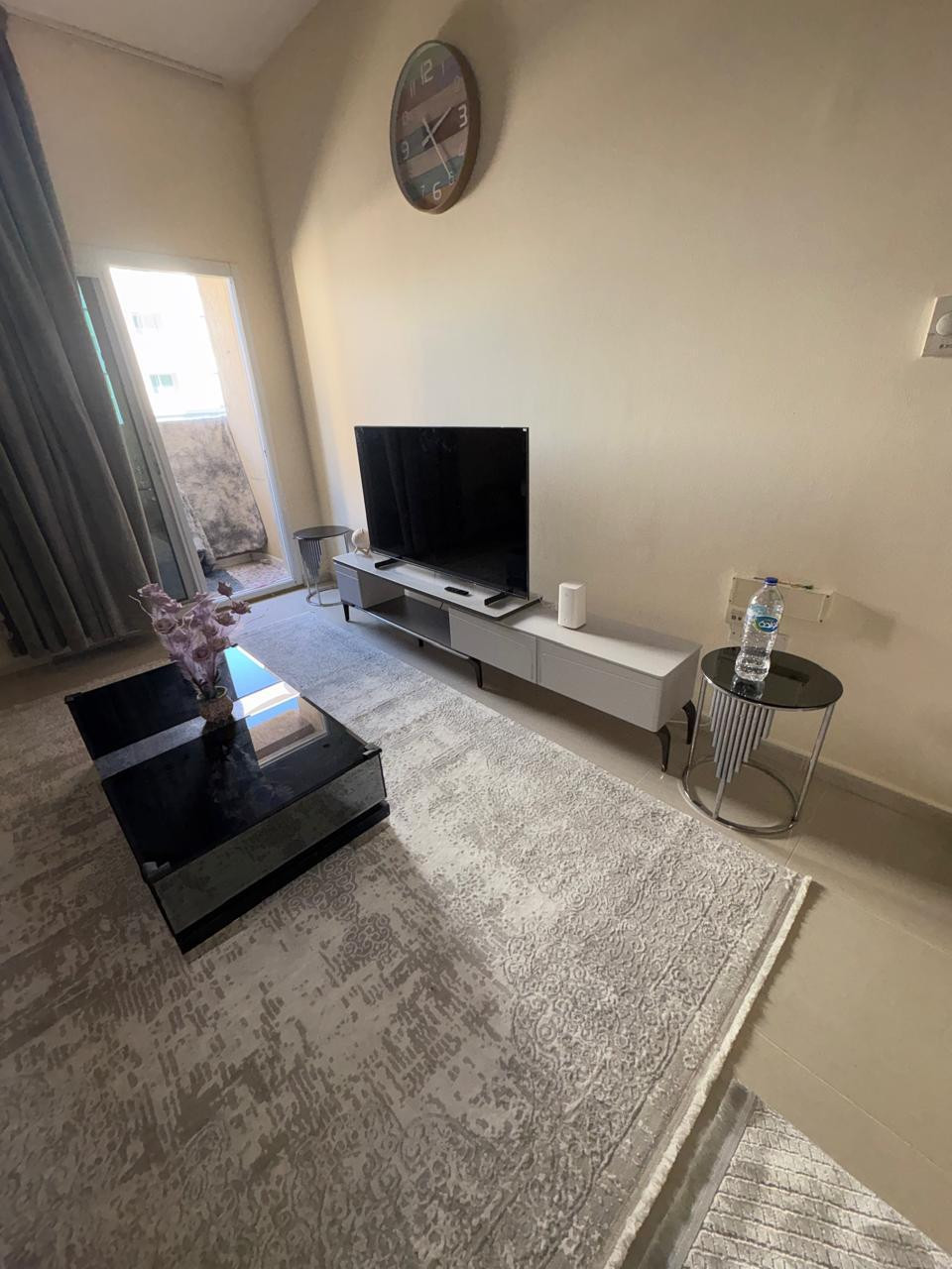 One bedroom and living room furnished with clean furniture and a balcony