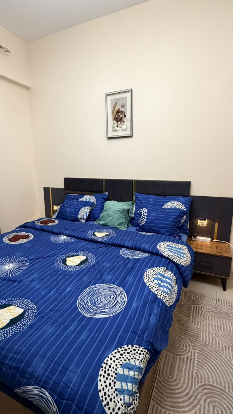 One bedroom and living room furnished with clean furniture and a balcony