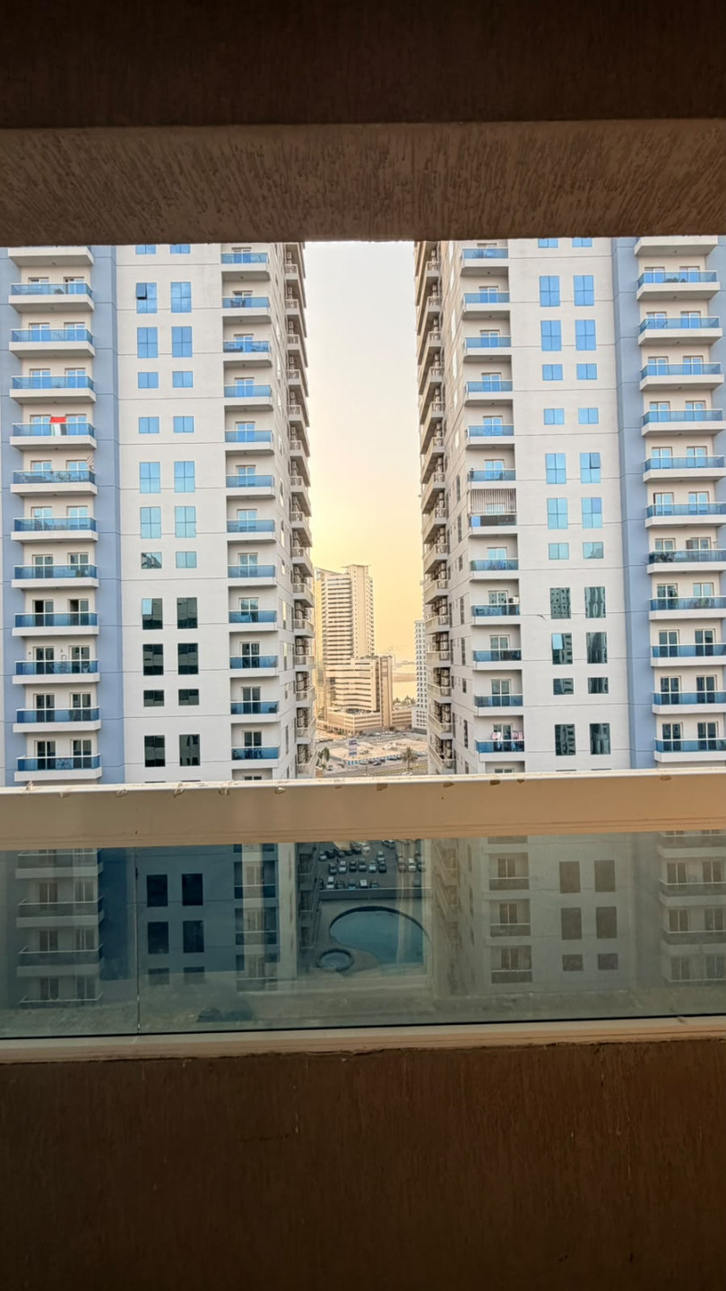 One bedroom and living room furnished with clean furniture and a balcony