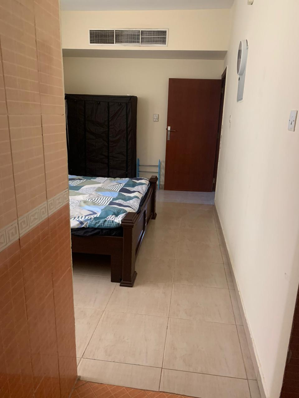 One bedroom and living room furnished with clean furniture
