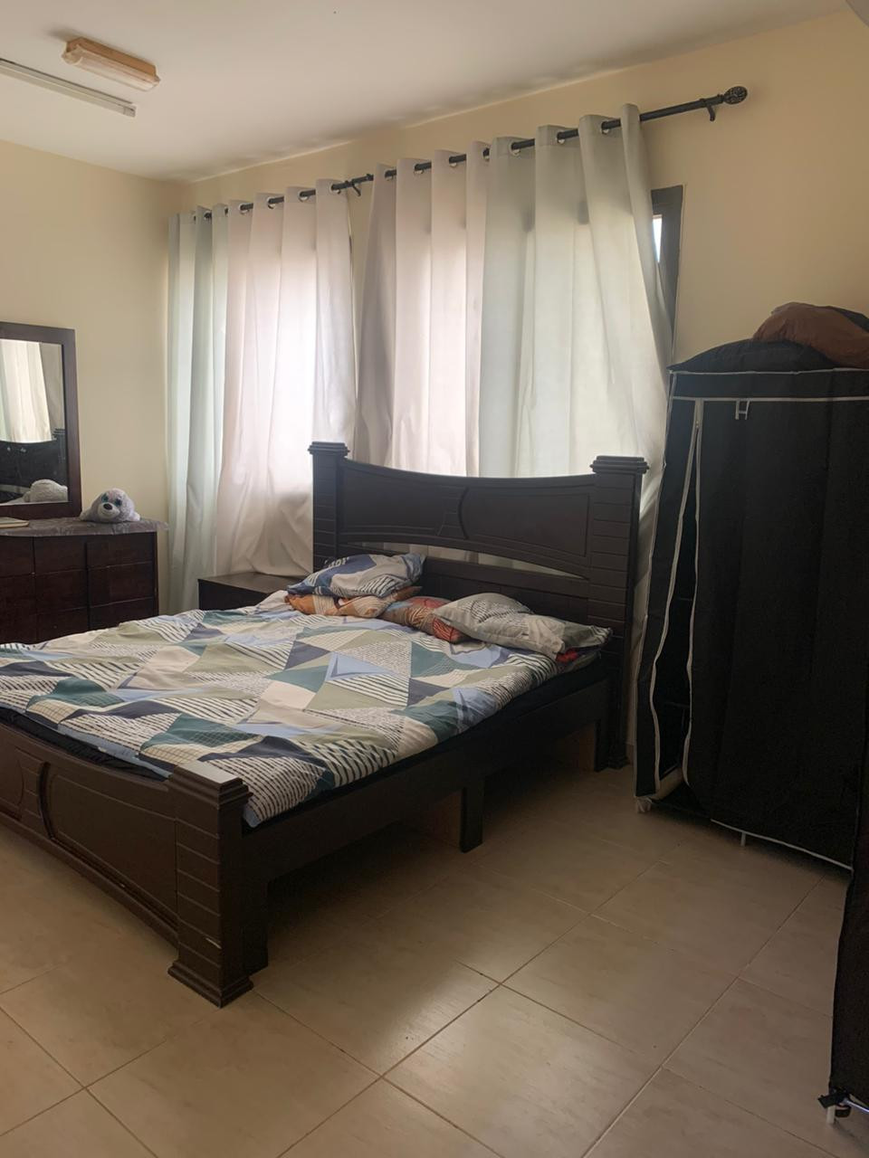 One bedroom and living room furnished with clean furniture