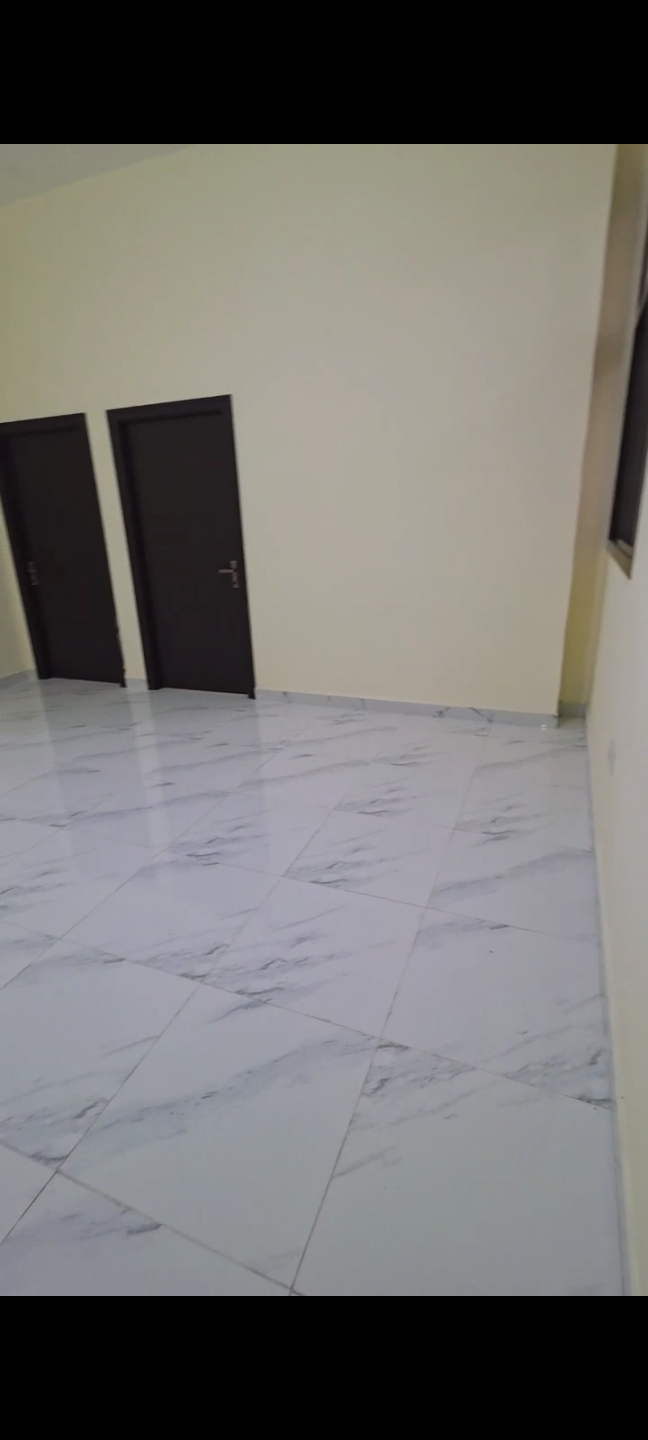 Two bedrooms and a living room in Mohammed Bin Zayed City