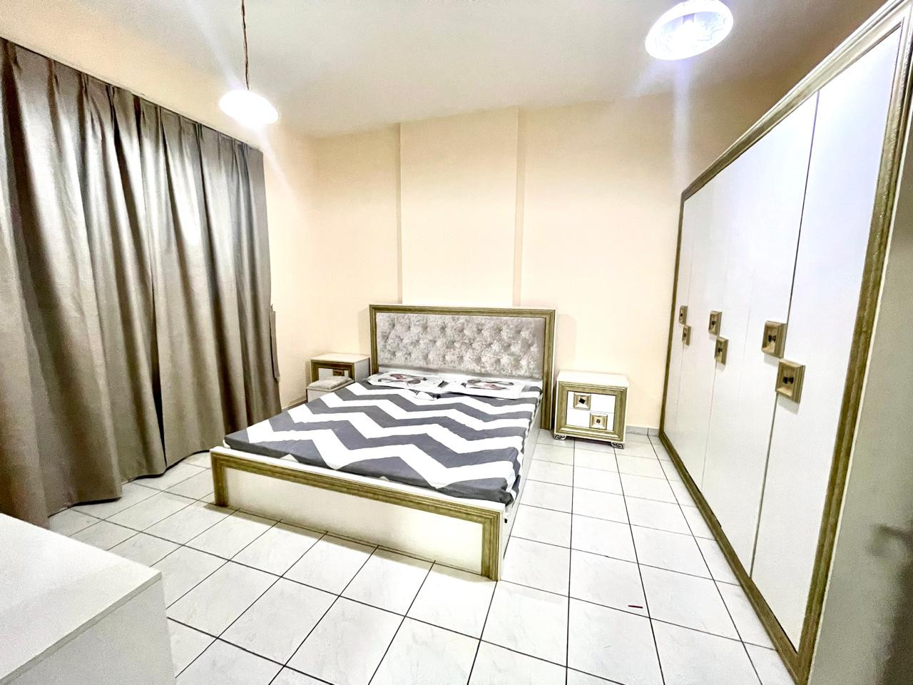 Two bedrooms and a living room with a balcony in Al Qasba