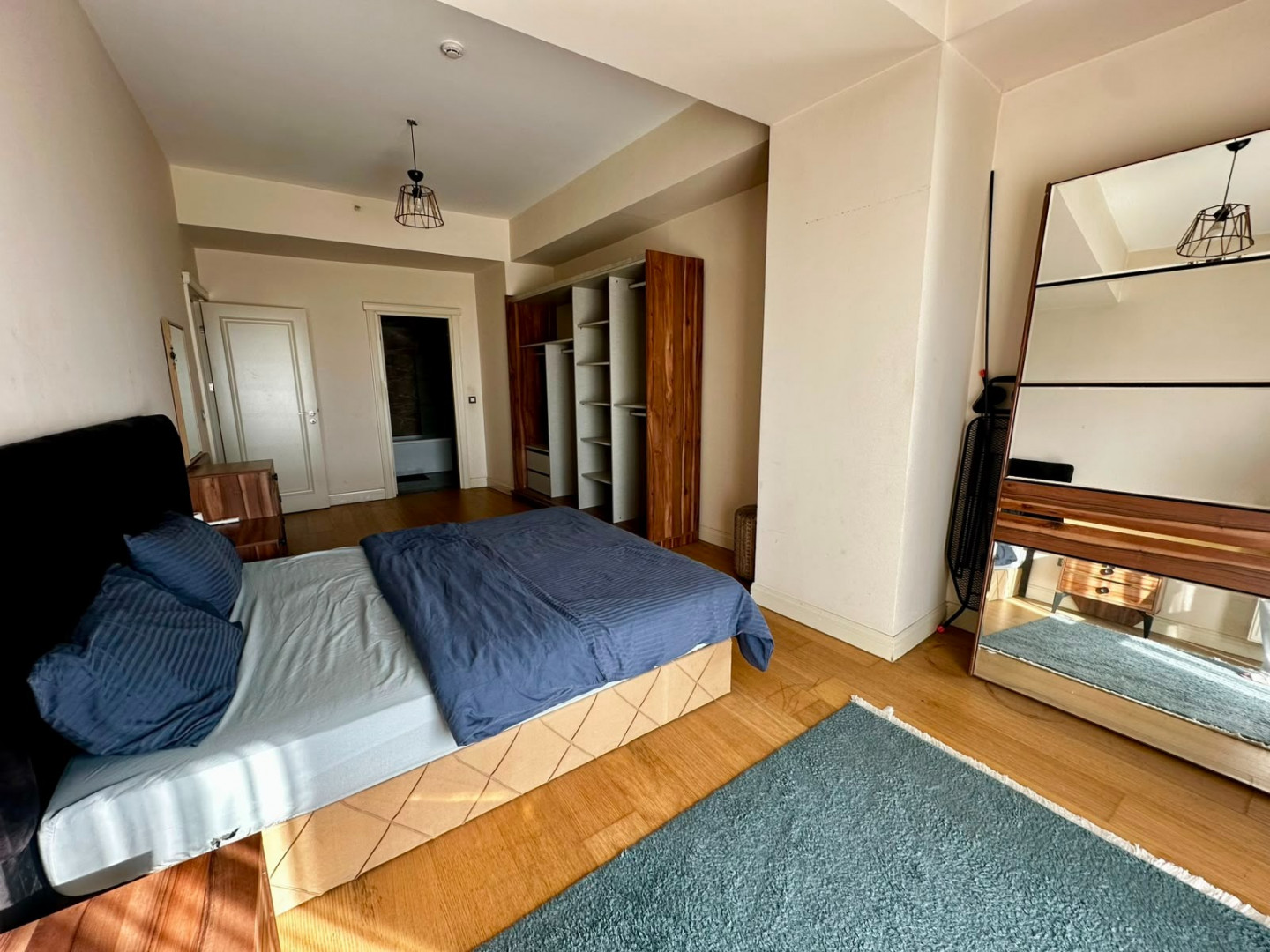 Two bedrooms and a living room with a view of the highway.