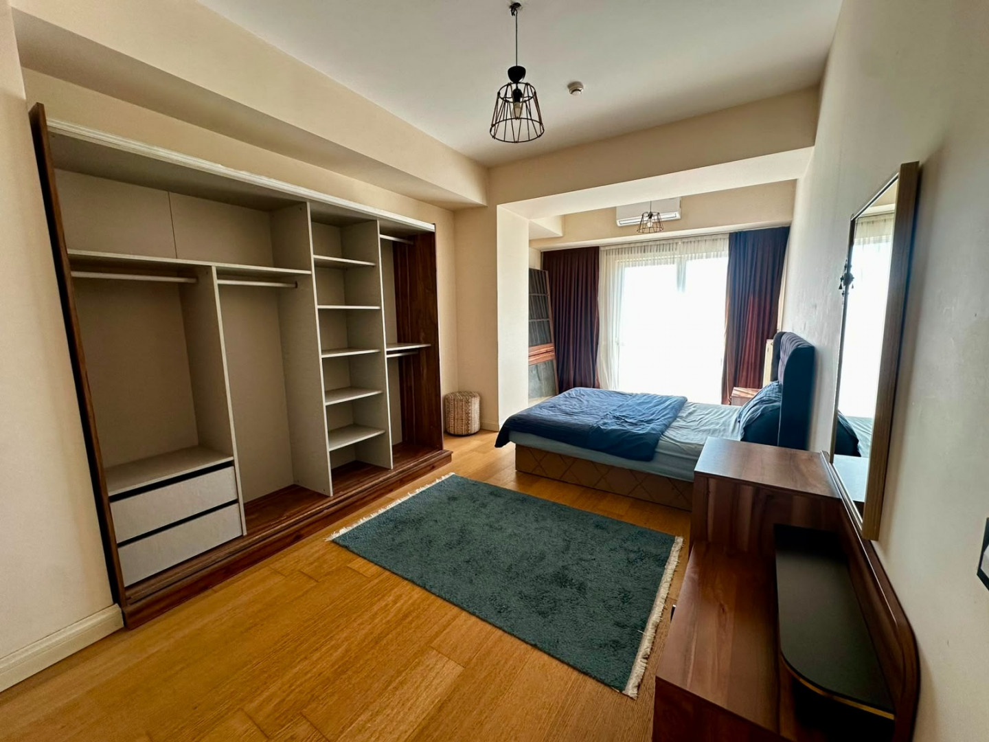 Two bedrooms and a living room with a view of the highway.