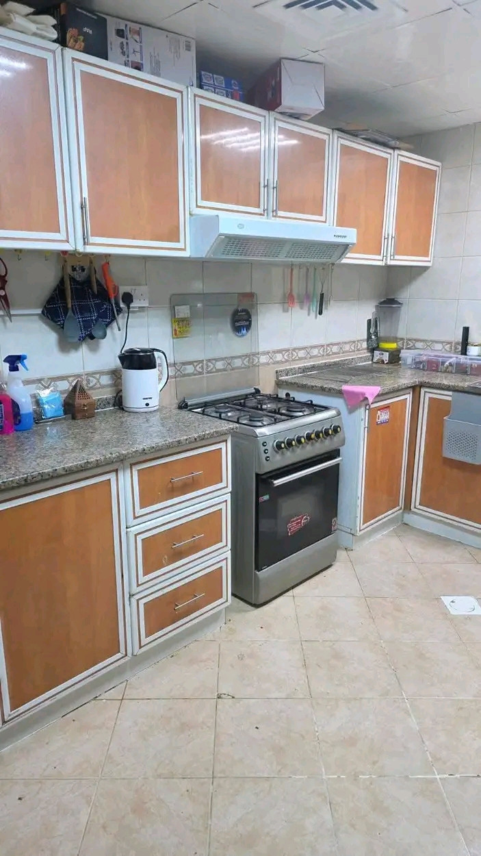 Two bedrooms and a living room with a balcony in Ajman