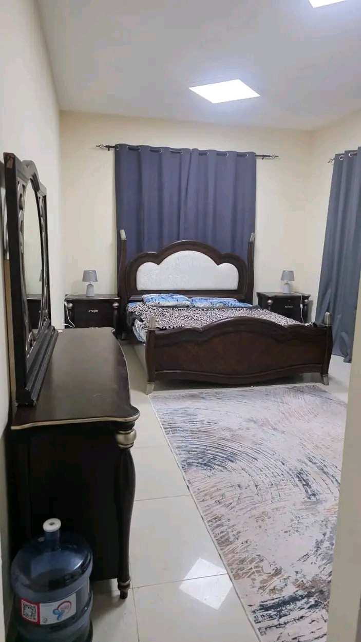 Two bedrooms and a living room with a balcony in Ajman