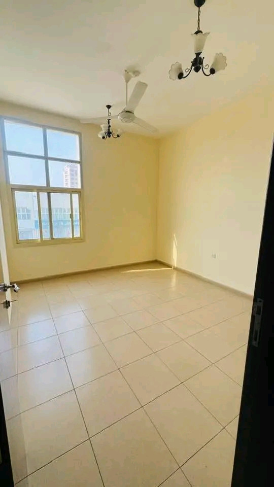 Two bedrooms, a living room, and a balcony overlooking the street with spacious areas.