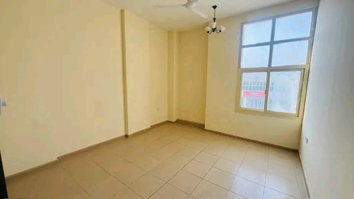 Two bedrooms, a living room, and a balcony overlooking the street with spacious areas.