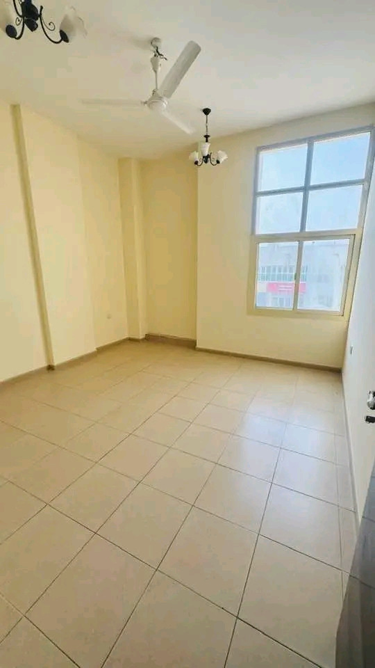 Two bedrooms, a living room, and a balcony overlooking the street with spacious areas.