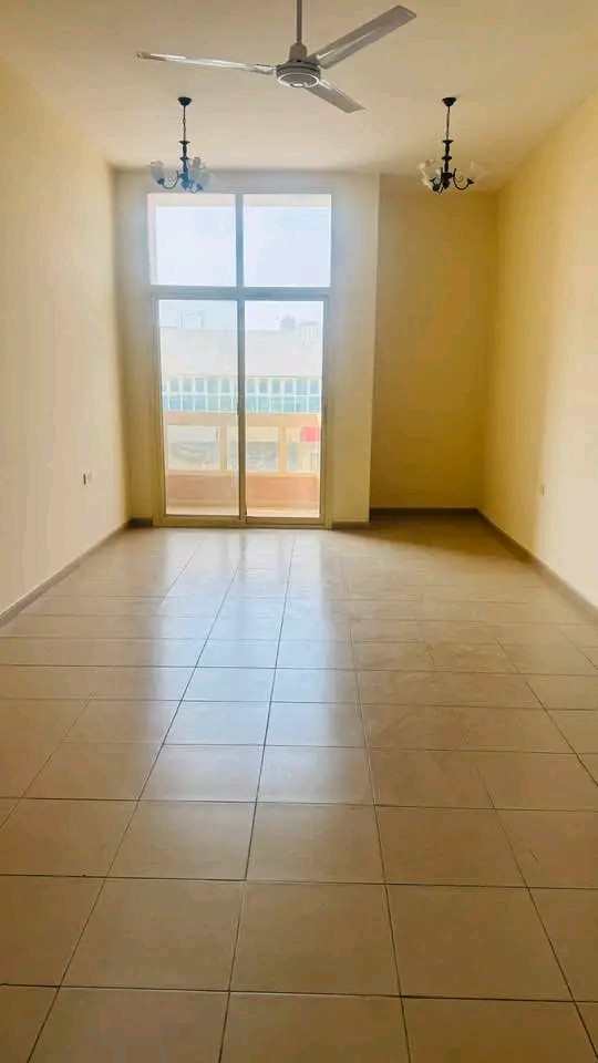 Two bedrooms, a living room, and a balcony overlooking the street with spacious areas.