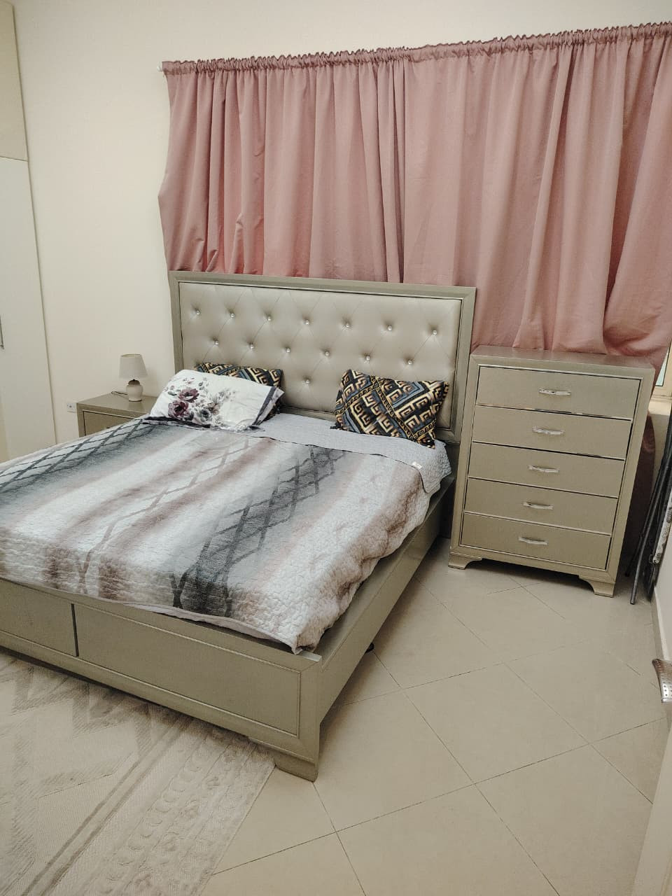 Two bedrooms and a living room, furnished with very clean furniture, and a bathroom.