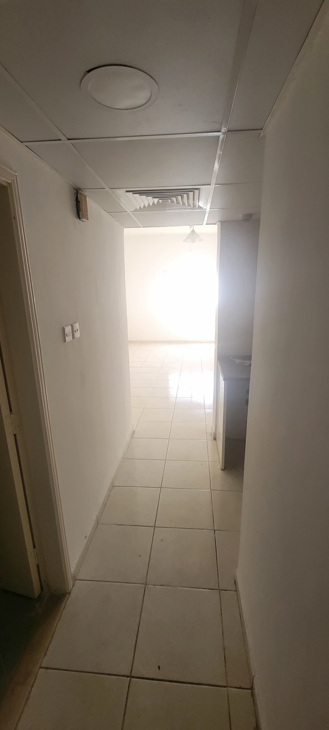 Studio apartment for annual rent in Al Rashidiya, behind Grand Mall, for 20,000 AED payable in 4 or 6 checks.