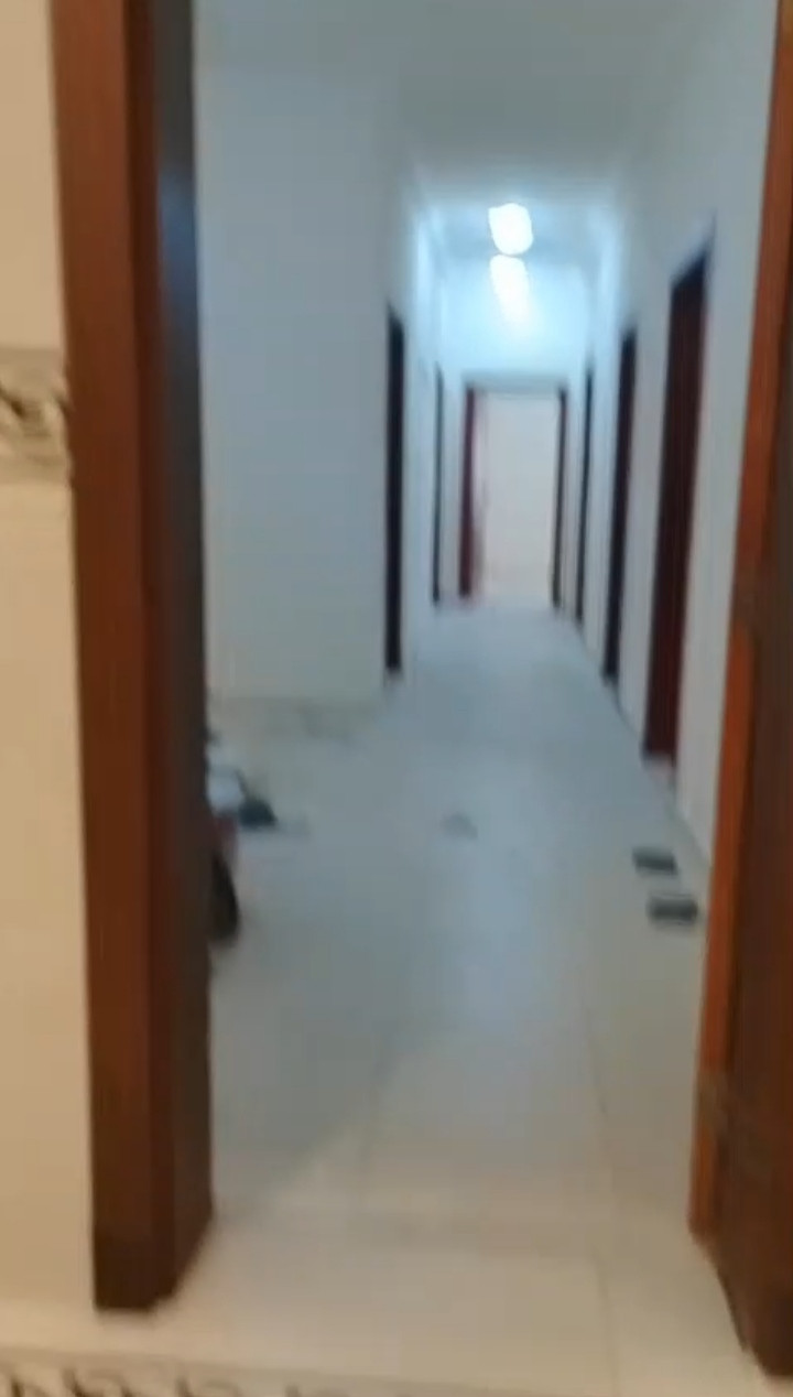 A distinctive apartment with a large kitchen and elevator.