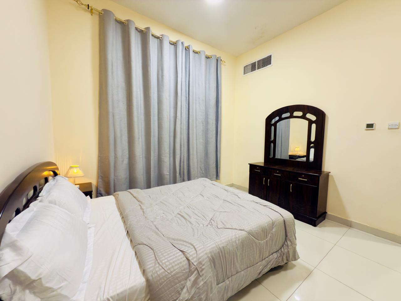 Central air conditioning, two-bedroom apartment with a living room, clean furnishings